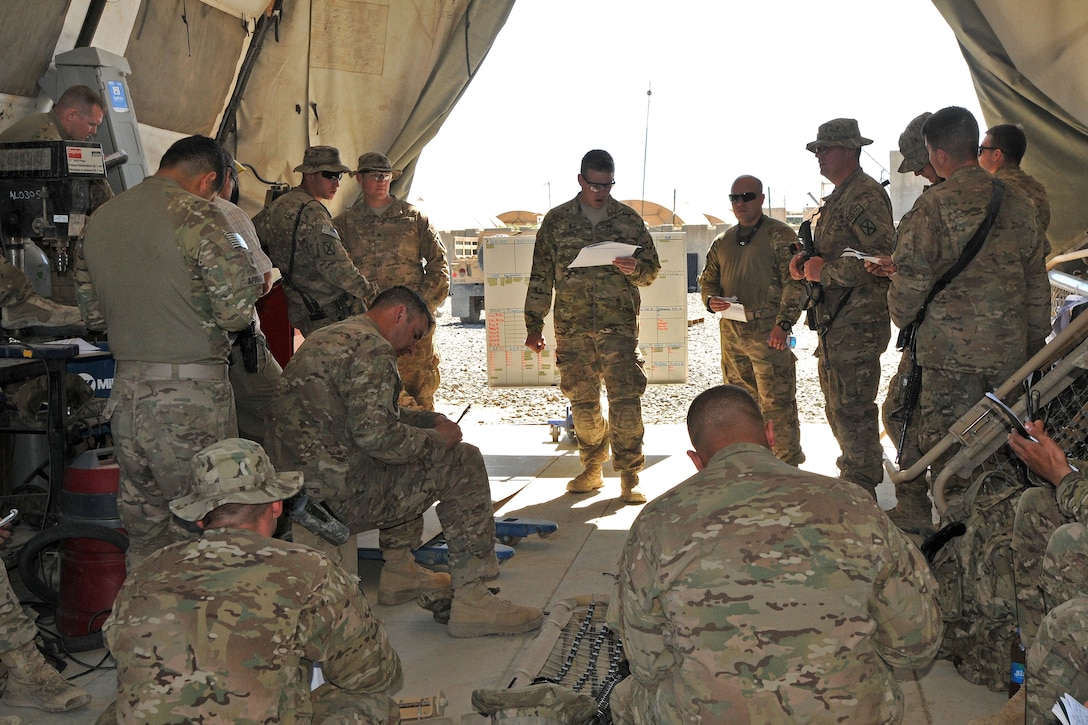 U.S. Army 1st Lt. Connor Gerencser, center, briefs his crews before a night route clearance mission on Forward Operating Base Shank in Afghanistan's Logar province, May 23, 2014. Gerencser, a platoon leader, is assigned to the 10th Mountain Division's Company A, 3rd Brigade Special Troops Battalion, 3rd Brigade Combat Team, Combined Arms Route Clearance Operation 30. The soldiers are tasked with ensuring the routes used by coalition forces remain free of improvised explosive devices.