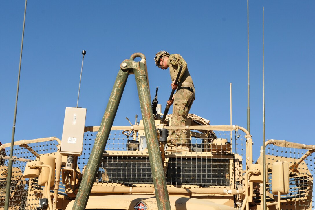 A U.S. soldier sets up his M2 machine gun on his tactical vehicle before a night route clearance mission on Forward Operating Base Shank in Afghanistan's Logar province, May 23, 2014.