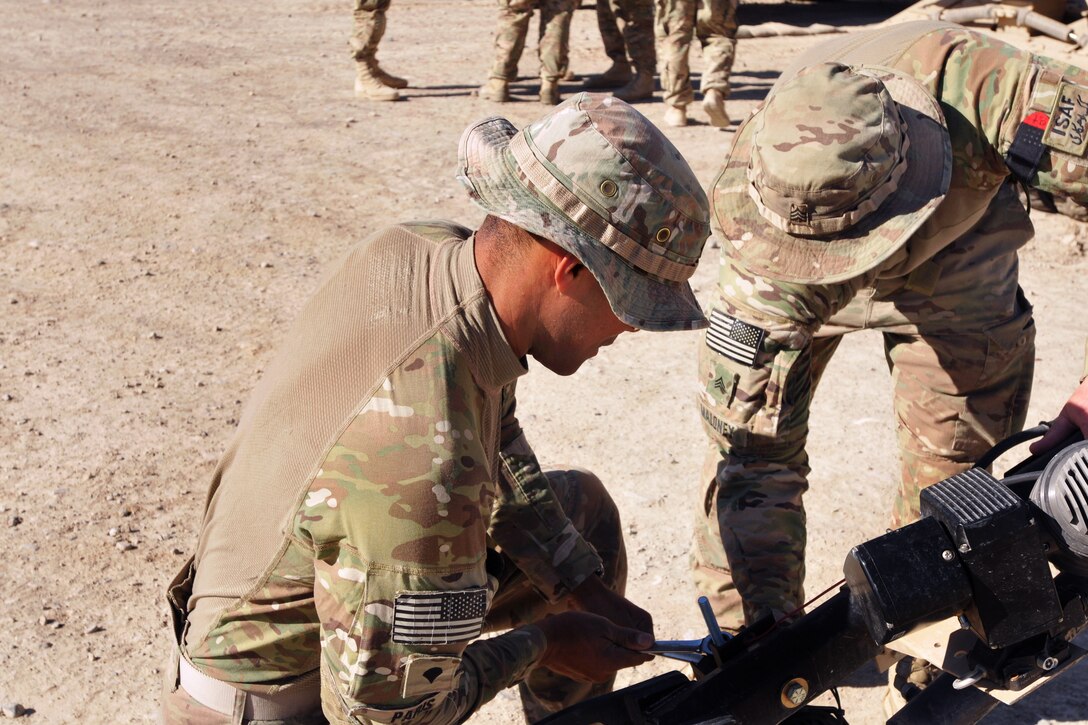 U.S. Army Sgt. Jeffrey Maloney, right, supervises U.S. Army Spc. Tomas Paris as he makes adjustments on a mechanical claw used for manipulating objects before a night route clearance mission on Forward Operating Base Shank in Afghanistan's Logar province, May 23, 2014. Maloney, a heavy equipment operator, and Paris, a mechanic, are assigned to the 10th Mountain Division's Company A, 3rd Brigade Special Troops Battalion, 3rd Brigade Combat Team, Combined Arms Route Clearance Operation 30.
