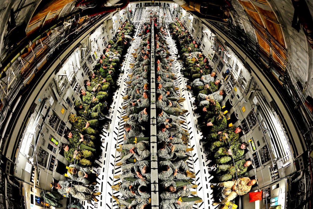 Army paratroopers and Canadian soldiers fill the cargo area of a Globemaster III aircraft during a joint operational access exercise on Pope Field, N.C., Feb. 9, 2012. The paratroopers are assigned to the 82nd Airborne Division's 3rd Brigade Combat Team.  
