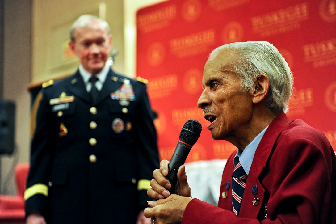 Retired Tuskegee Airman Lt. Col. Herbert Carver addresses the audience as Army Gen. Martin E. Dempsey, chairman of the Joint Chiefs of Staff, listens at Tuskegee University, Ala., Feb. 21, 2012. 
