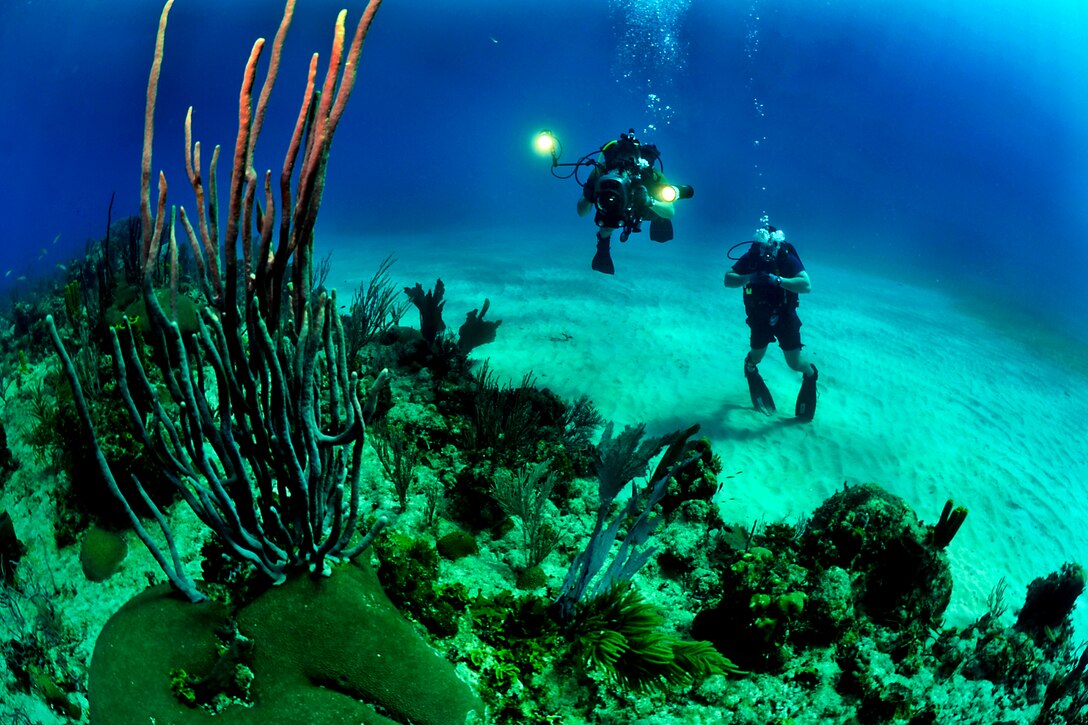 U.S. Navy Petty Officer 1st Class Jayme Pastoric supervises U.S. Navy Petty Officer 3rd Class Scott Raegen during underwater videography training off the coast of Guantanamo Bay, Cuba, Feb. 9, 2012. The underwater photo team, assigned to Expeditionary Combat Camera, conducts semi-annual training to ensure support of U.S. Defense Department activities worldwide. 
