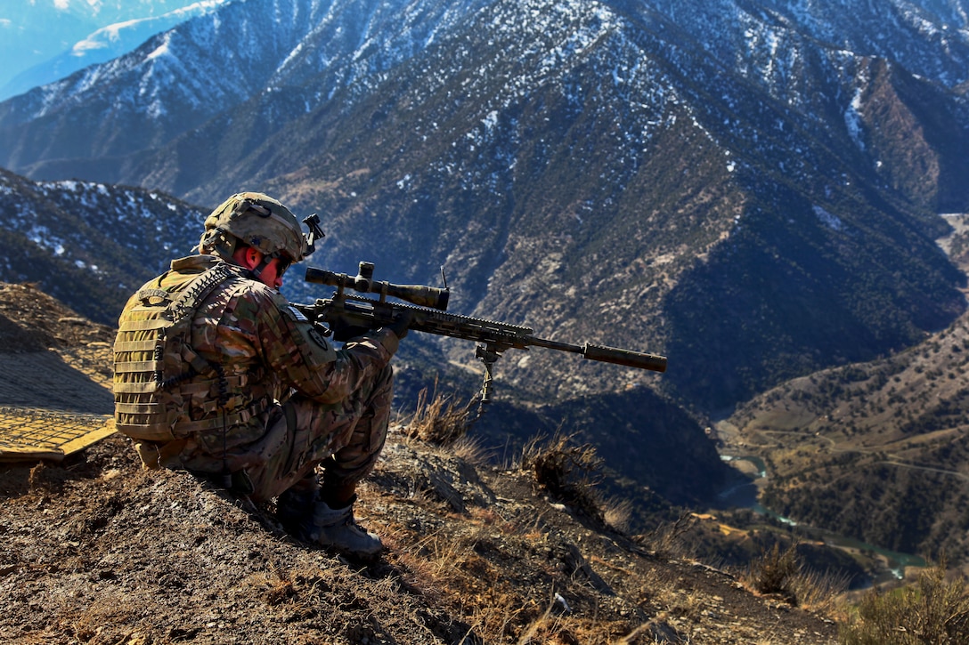 U.S. Army Cpl. Kevin Dehaven uses his weapon's scope to scan the valley while providing security on Observation Post Mangol in the Nari district in Afghanistan's Kunar province, Feb. 8, 2012. Dehaven is a sniper team leader assigned to the 25th Infantry Division's Headquarters Company, 2nd Battalion, 27th Infantry Regiment, 3rd Brigade Combat Team.  

