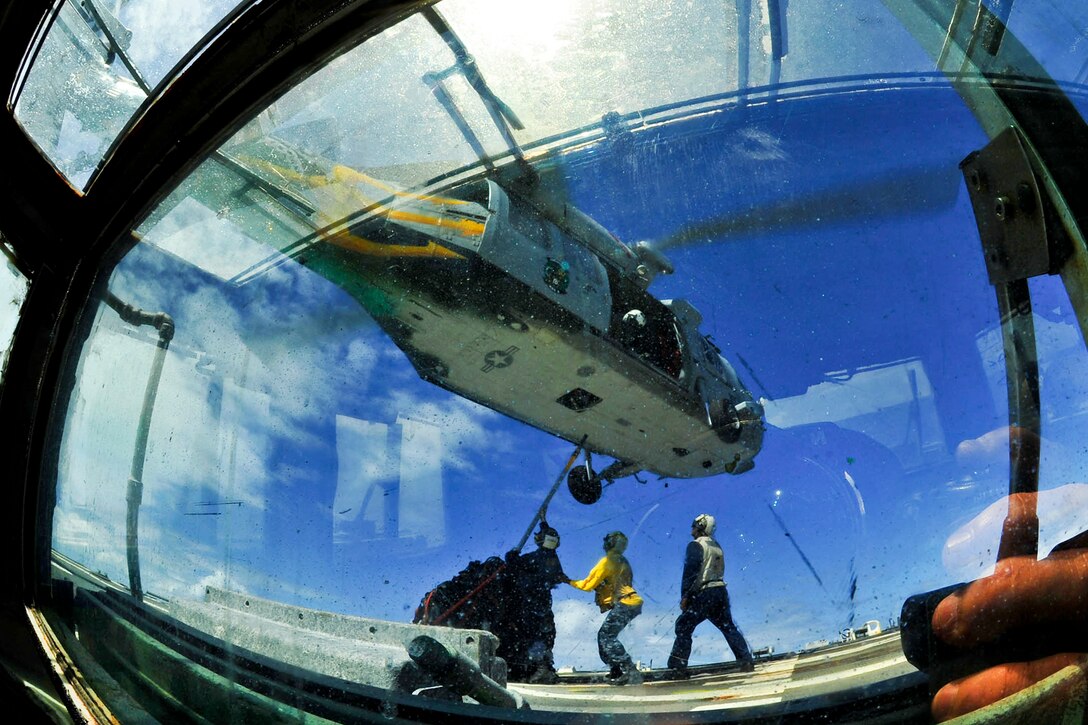 U.S. sailors aboard the guided-missile destroyer USS Pinckney connect a pallet to an MH-60S Sea Hawk helicopter during a vertical replenishment in the Pacific Ocean, Feb. 12, 2012. The Pinckney, part of the John C. Stennis Carrier Strike Group, is operating in the U.S. 7th Fleet area of responsibility conducting maritime security operations. The helicopter is assigned to Helicopter Sea Combat Swuadron 8.  
