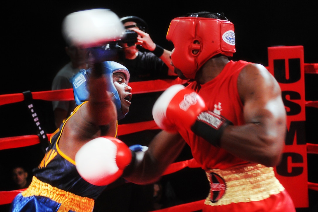 Navy Seaman Brandon Wicker, left, throws an overhead right hook during a boxing match against Marine Cpl. Darnell Price in the bronze-medal bout of the 2012 Armed Forces Boxing Championship on Camp Pendleton, Calif., Feb. 1, 2012. Wicker, a hospital corpsman, fights for the U.S. Navy Boxing Team in the 201-pound weight class. He won his match 14-12.  
