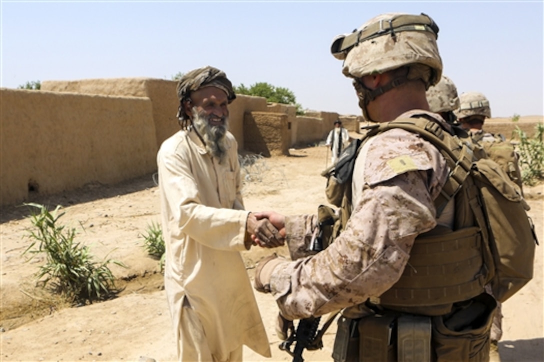 U.S. Marines Corps 2nd Lt. Michael Bressler shakes hands with an Afghan elder during a security patrol near the town of Boldak in Helmand province, Afghanistan, May 21, 2014. Bressler, a platoon commander, is assigned to 1st Battalion, 2nd Marine Regiment. 