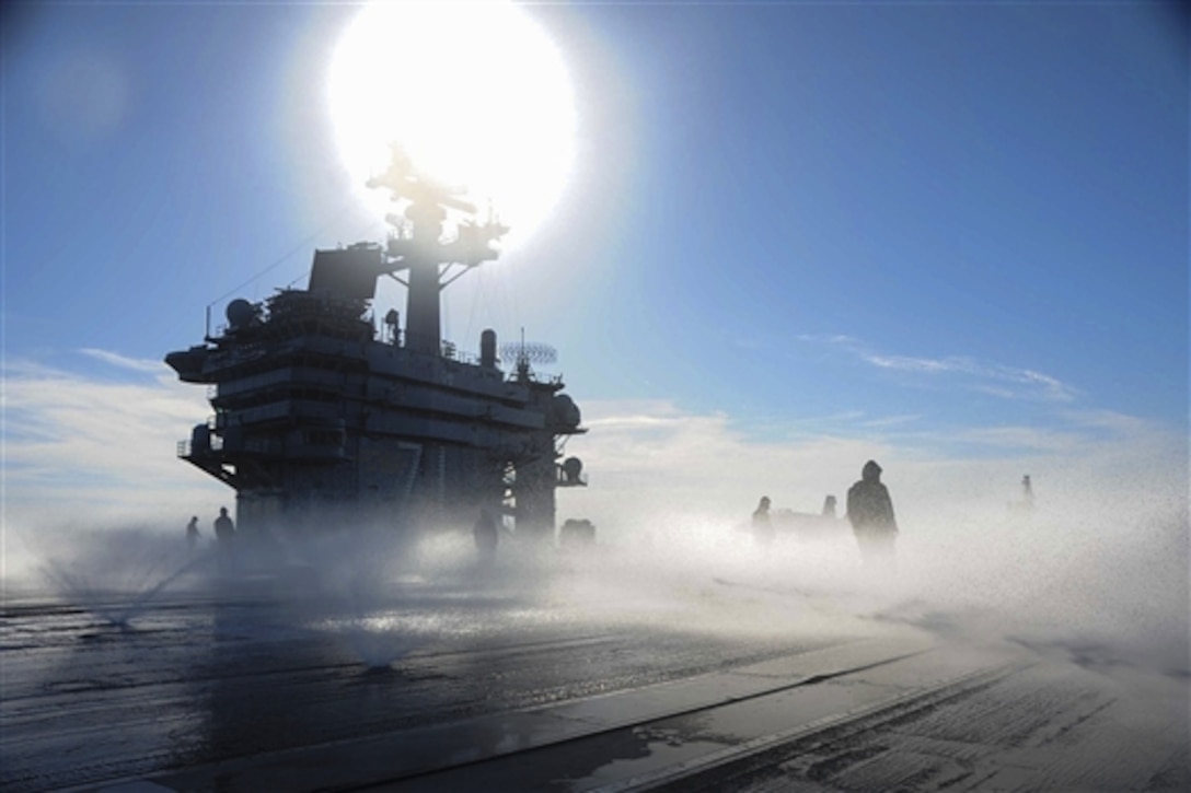 U.S. Navy sailors aboard the aircraft carrier USS Theodore Roosevelt participate in a test of the aqueous film-forming foam flight deck firefighting system in the Atlantic Ocean, June 2, 2014. The Theodore Roosevelt is underway conducting training exercises in preparation for future deployments. The foam rapidly extinguishes hydrocarbon fuel fires. 