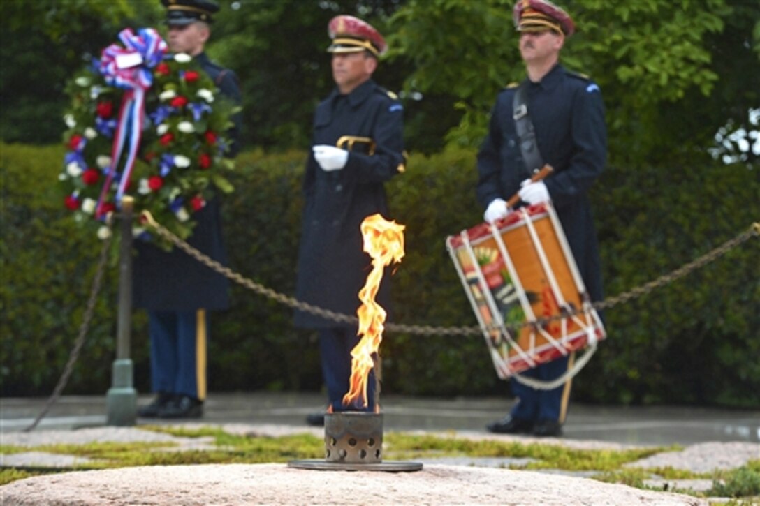 Members of the U.S. Army Honor Guard, 3rd U.S. Infantry Regiment, participate in a ceremony to mark what would have been President John F. Kennedy’s 97th birthday, at the site of his grave in Arlington National Cemetery, Va., May 29, 2014. 