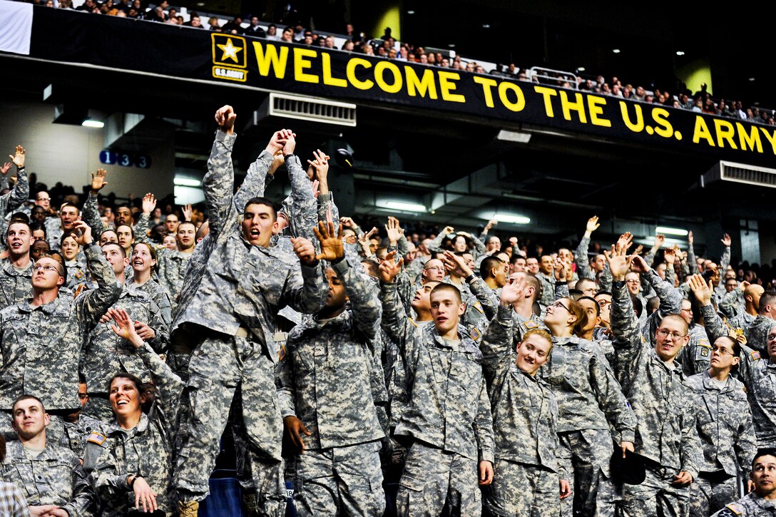 Soldiers jump to catch mini-footballs during the Army All-American Bowl at the Alamodome in San Antonio, Jan. 7, 2012. The soldiers are assigned to advanced individual training units.  
