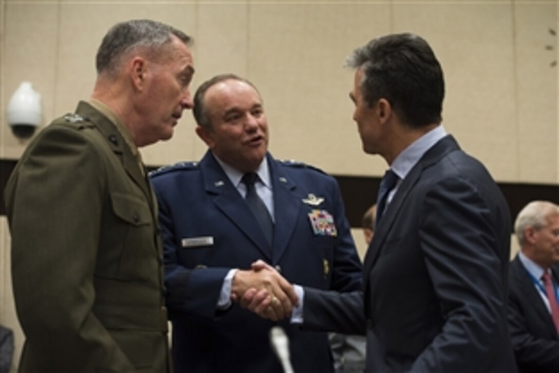 U.S. Marine Corps Gen. Joseph F. Dunford Jr., left, commander of the International Security Assistance Force in Afghanistan, and U.S. Air Force Gen. Philip M. Breedlove, center, commander of U.S. European Command and supreme allied commander, Europe, speak with NATO Secretary General Anders Fogh Rasmussen at NATO headquarters in Brussels, June 4, 2014. 