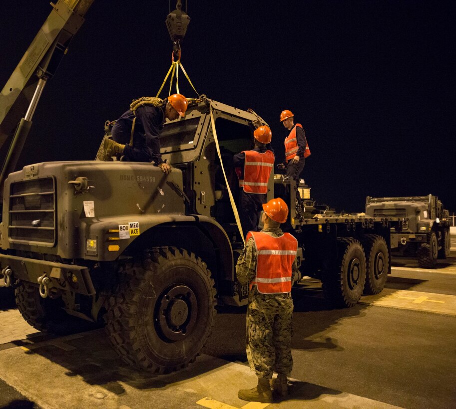 Marines assigned to 3rd Maintenance Battalion, Combat Logistics Regiment 35, 3rd Marine Logistics Group, III Marine Expeditionary Force, conduct a cab-rebuild of a 7-ton truck after offloading selective gear at Subic International Port April 24, in Subic Bay, Philippines. The Marines were part of the Offload Preparation Party, which is responsible for preparing gear before docking to offload as efficient as possible once in port. The selective offload took vehicles and equipment from the USNS 2nd Lt. John P. Bobo to support Exercise Balikatan 2014. (U.S. Marine Corps photo by Lance Cpl. Joey S. Holeman, Jr./ Released)