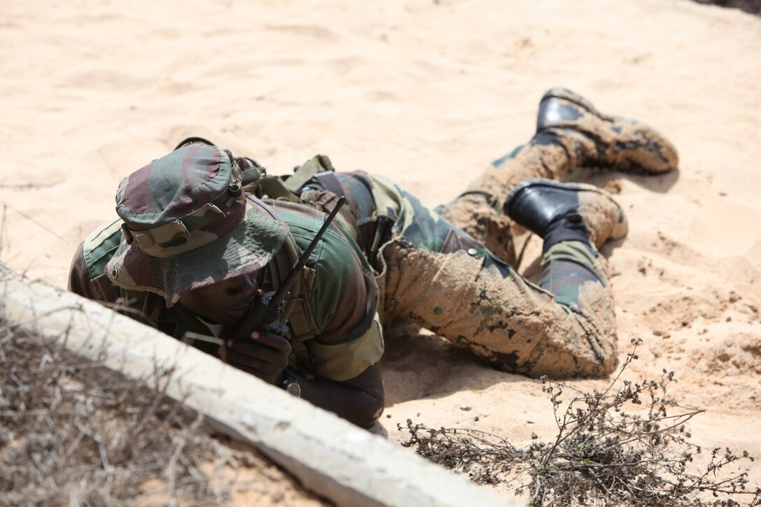 A Senegalese Commando from the Compagnie Fusilier de Marine Commandos, or COFUMACO, coordinates an assault on a beachhead in Dakar, Senegal, May 16, 2014. A group of U.S. Marines from Special-Purpose Marine Air-Ground Task Force Africa 14, from 3rd Battalion, 8th Marine Regiment, partnered with the COFUMACO to enable a cadre of their own to conduct training in infantry and amphibious tactics for the rest of their company.