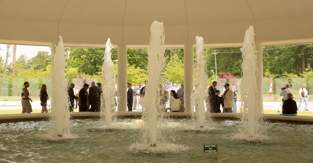 Guests at the rededication ceremony of the Vietnam Veterans Memorial stand near fountains, each jet representing the different branches of the military, at Lejeune Memorial Gardens in Jacksonville, N.C., May 31. The ceremony honored the memory of those who perished during the war and celebrated the accomplishments and perseverance of Vietnam-era veterans.(U.S. Marine Corps photo by Cpl. Jackeline M. Perez Rivera/Released)