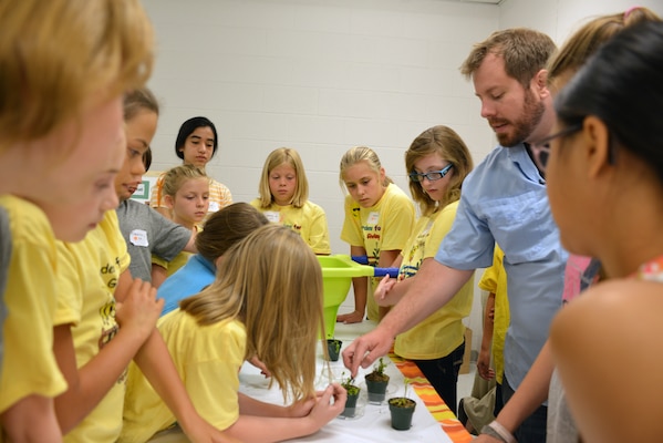 Casey Ehorn, a wetland biologist  with the U.S. Army Corps of Engineers Nashville District Regulatory  Branch, explains the Venus flytrap plant to  kids at the Williamson County Junior Gardener Camp at the Agricultural Exposition Park June 3, 2014. 