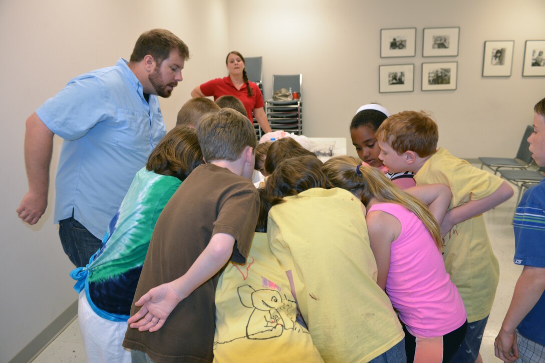 Casey Ehorn, a wetland biologist  with the U.S. Army Corps of Engineers Nashville District Regulatory  Branch, explains soil variations about the Venus flytrap to  kids at the Williamson County Junior Gardener Camp at the Agricultural Exposition Park June 3, 2014. 