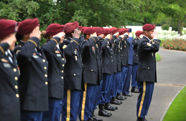 Members of the 5th Quartermaster Theater Aerial Delivery Company and the 435th Air Ground Operations Wing's Contingency Response Group salute the grave of Pvt. Richard Vargas during a wreath laying ceremony June 2, 2014, at Lorraine American National Cemetery and Memorial, St. Avold, France. Seventy years ago on June 7, 1944, Vargas lost his life during the invasion of Normandy. (U.S. Air Force photo/Senior Airman Hailey Haux)