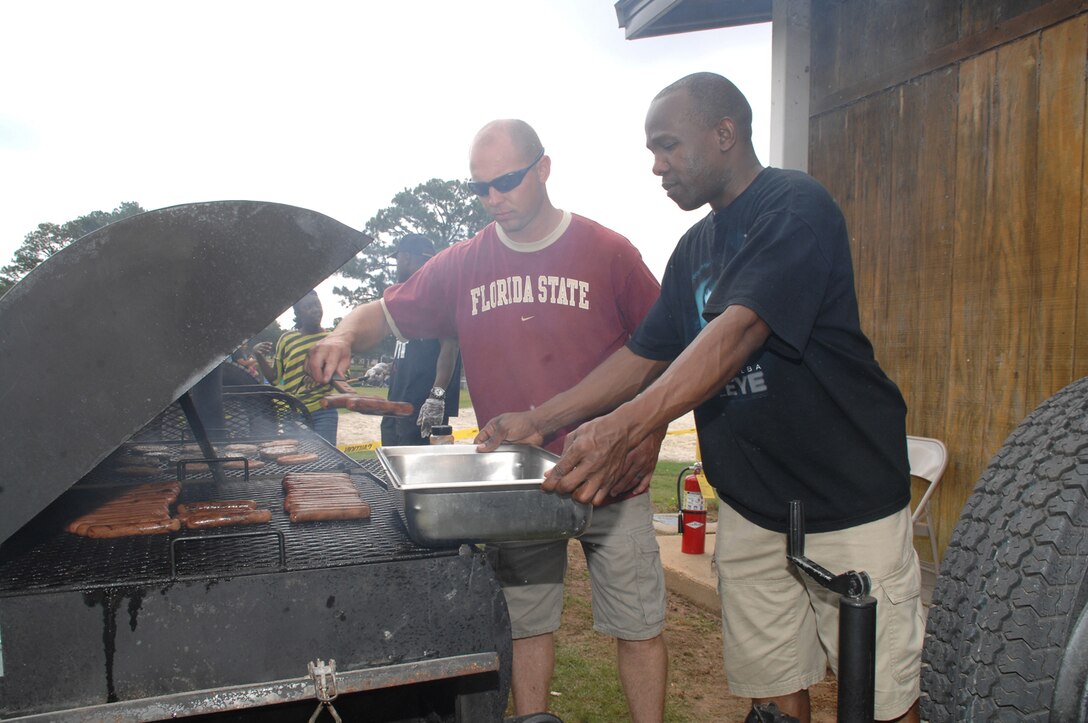 Attendees at the Marine Corps Logistics Command and Marine Corps Logistics Base Albany Unit and Family Fun Day feast on grilled hamburgers and hot dogs at Covella Pond here, May 30.