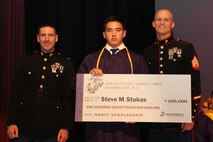 Steve Stukas, a senior at Elkhorn Area High School, poses for a photo with Capt. Matthew Baker, the Operations Officer of Recruiting Station Milwaukee, and Sgt. Nathan Krohn, the Non-Commissioned Officer in Charge of Recruiting Substation Racine, during the high school’s awards night June 4, 2014.