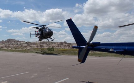 Soldiers with the South Dakota Army National Guard land a UH-72 Lakota helicopter in a parking lot while assisting the National Park Service in a rescue mission in Badlands National Park, near Interior, S.D., June 7, 2012. Four Soldiers assisted in a cable-hoist extraction of a park visitor who was hiking, fell and was injured on Notch Trail.