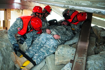 A Chemical, Biological, Radiological, Nuclear and high-yield Explosives Enhanced Response Force package team participating in Operation Makani Pahili 2012, extracts a mock-victim from a rubble pile June 5, 2012 in Oahu, Hawaii. The exercise, which took place June 4 to June 8, was a state-wide, multi-agency emergency response exercise designed to test Hawaii's capabilities in the case of a natural disaster.