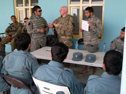 Army Maj. Roderick J. Cassidy, center, a member of the New York Army National Guard deployed with the judge advocate general office of the U.S. Army Stabilization Transition Team, 3rd Brigade, 2nd Infantry Division, goes over aspects of Afghan criminal law to leaders of the Afghan Uniformed Police Qalat Substation 1 as he conducts a refresher class in Afghan criminal law at the Provincial Meeting Center in Qalat City June 5, 2012. Cassidy taught a refresher course on Afghan criminal law to the Afghan police officers as a way to build greater law enforcement capacity within the AUP.