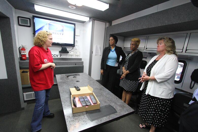 NORFOLK, Va. -- Norfolk District employees gathered in Baltimore District's Deployable Tactical Operations System to listen to its crew members explain the capabilities of the DTOS May 19, 2014. The trip allowed the crew to meet training requirements while complementing Norfolk District's hurricane contingency planning that day.  The Norfolk District's Continuity of Operations meeting anticipated needs, abilities and work-arounds for the more than 300 Norfolk District employees in the case the building was heavily damaged during a storm. The deployable operations systems offers work stations, a video teleconference room, wireless capabilities, and three days of power from one tank of diesel fuel and deploys to an area of need after a a presidential disaster declaration and a Federal Emergency Management Agency tasking. (U.S. Army photo/Kerry Solan)