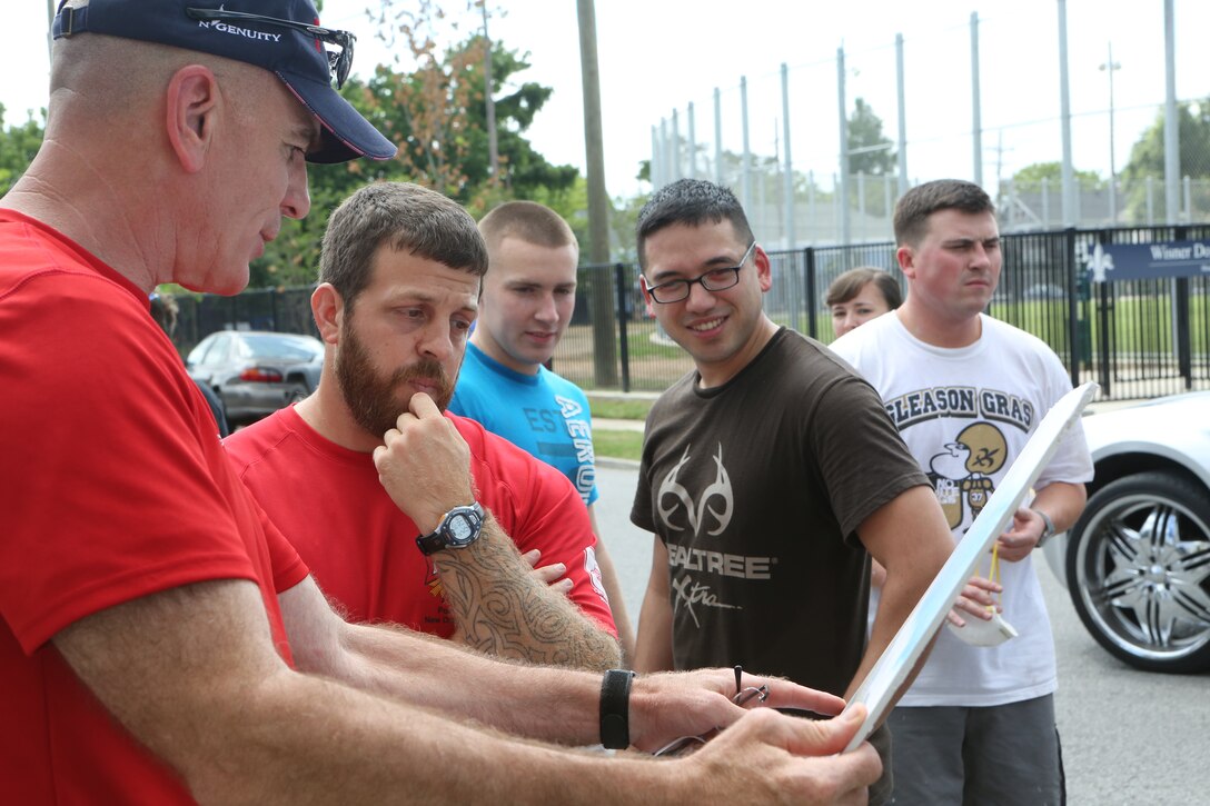 Sgt. Maj. Bryan Battaglia, senior enlisted advisor to the Chairman of the Joint Chiefs of Staff, and fellow volunteers look over the plans for reconstructing the Veterans of Foreign Wars Post 8973, June 4, 2014. Reconstruction of the post will allow veterans to have access to all the services VFW offers. Marines from Marine Forces Reserve and Naval Air Station-Joint Reserve Base Belle Chasse volunteered to help the renovation get started and provide a place for veterans to enjoy. (U.S. Marine Corps photo by Lance Cpl. Sara Graham)