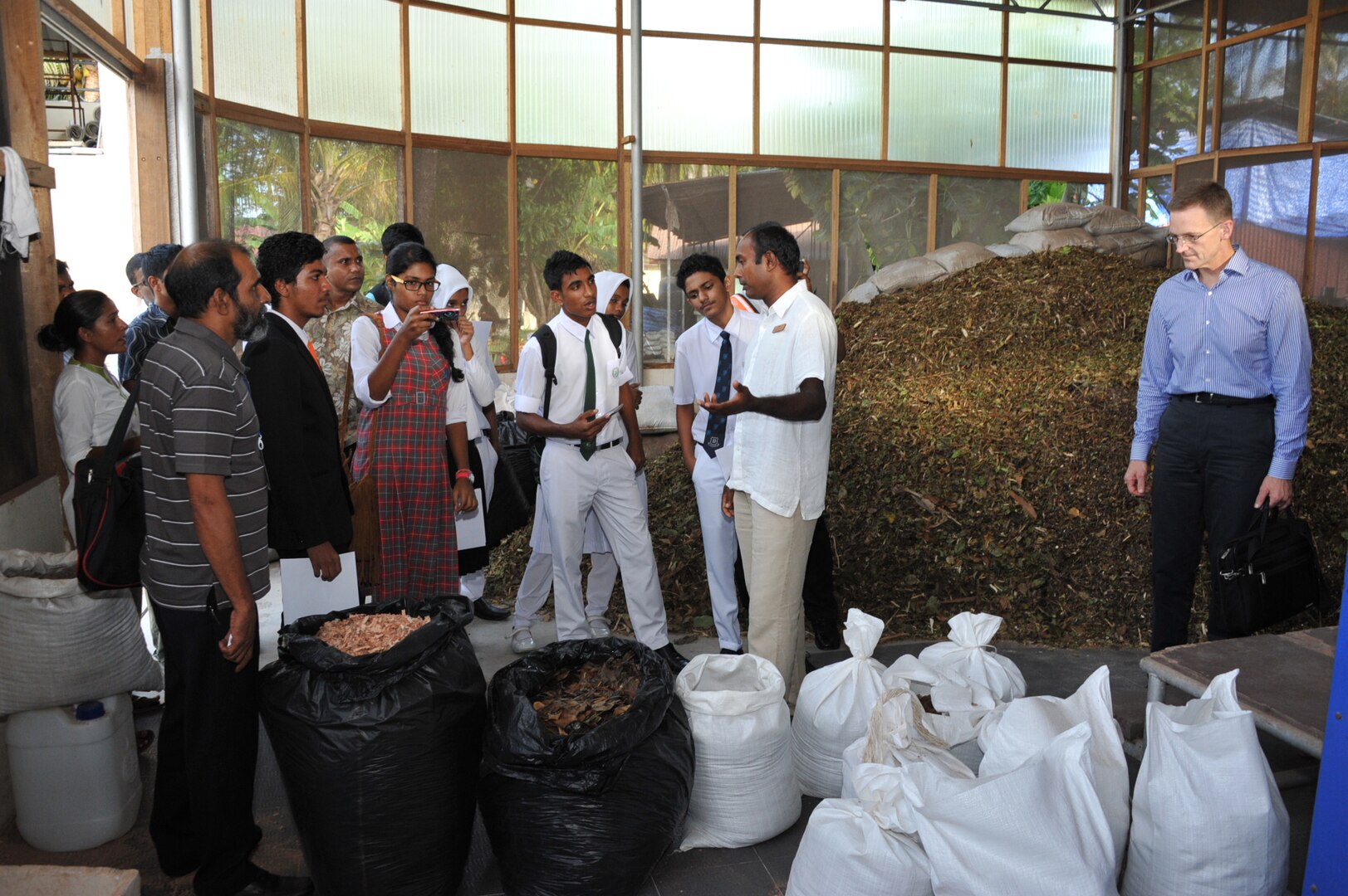 THULUSDHOO ISLAND, Maldives (June 4, 2014) Brig. Gen. Mark McLeod of U.S. Pacific Command tours a Maldivian business using environmentaly sustainabile practices with a group of school students from the Maldives at the South Asia Regional Environmental Security Forum. The Forum, which was held June 2-5 in the Maldives, involved representatives from nations throughout South Asia, international governmental organizations, and observers and promotes regional cooperation on the topics of water security, waste management, resource protection and energy.  (US Army photo by Justin Pummell/Released)