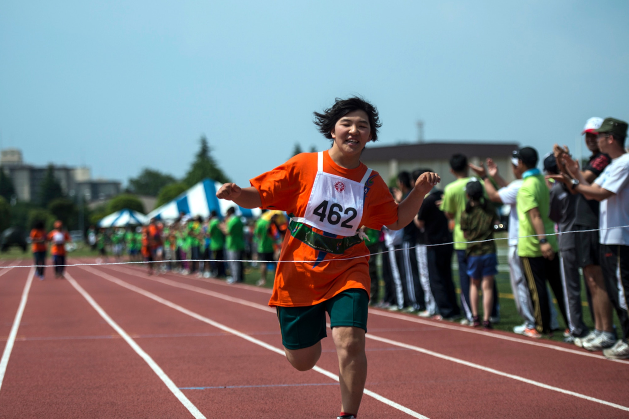 An athlete crosses the finish line during the Kanto Plains Special Olympics May 31, 2014, at Yokota Air Base, Japan. This year marked the 35th Anniversary of the games at Yokota. (Courtesy photo by Staff Sgt. Asa McQueen/Released)