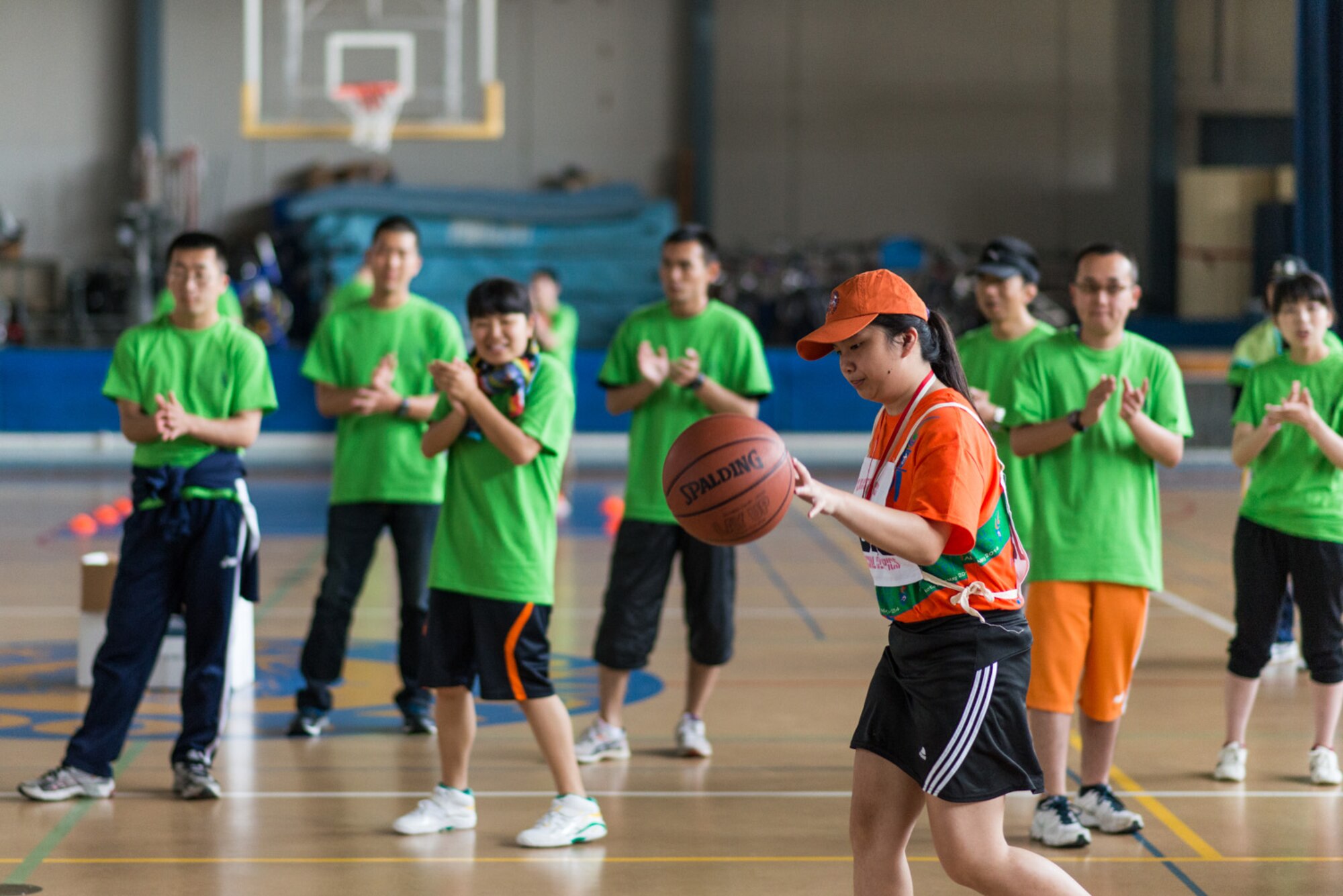 An athlete dribbles a ball during the basketball shoot at the Kanto Plains Special Olympics at Yokota Air Base, Japan, May 31, 2014. Athletes had the opportunity to participate in track and field events, basketball, softball, swimming and bowling events. (Courtesy photo by Staff Sgt. David Gevert/Released)