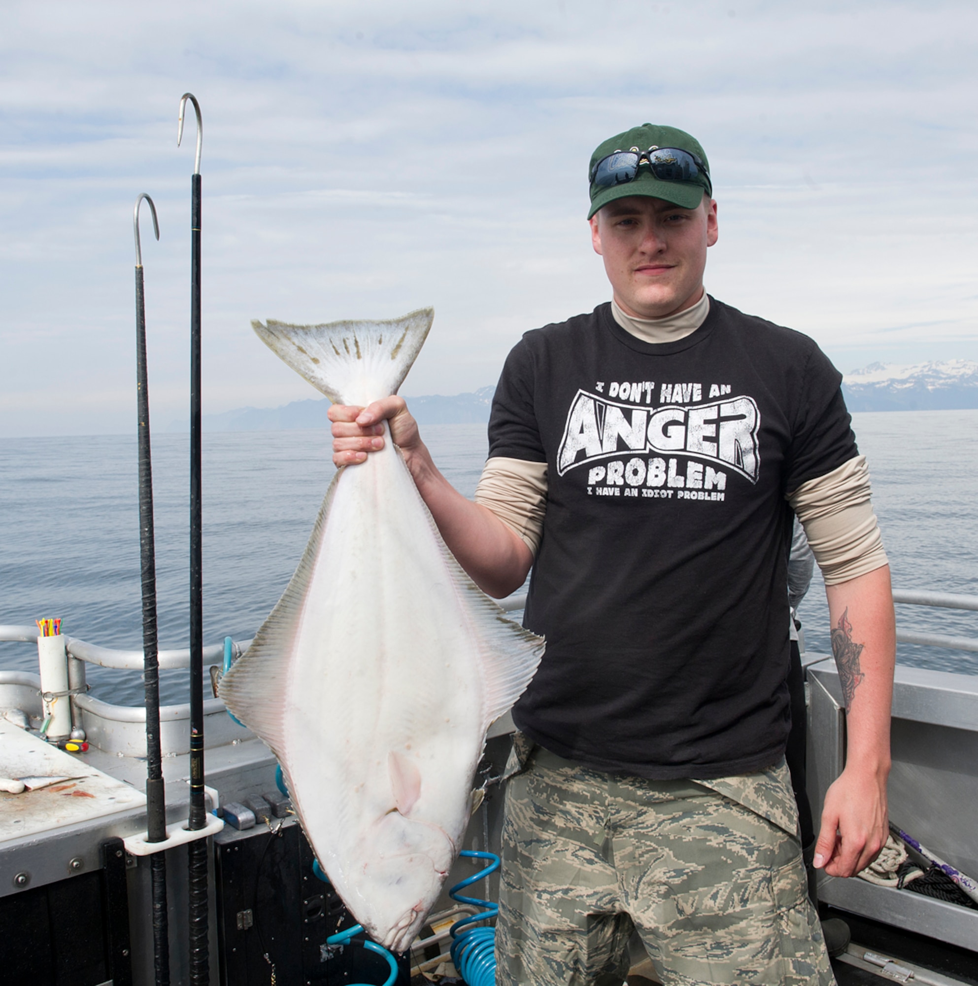 Senior Airman Kyle Griffioen, 703rd Aircraft Maintenance Squadron aerospace propulsions technician, holds a halibut he caught during the Annual Armed Services Combat Fishing Tournament in Seward, Alaska, May 22, 2014. The tournament is put on annually to honor active duty service members who have deployed or are scheduled to deploy. (U.S. Air Force photo/Staff Sgt. Zachary Wolf)