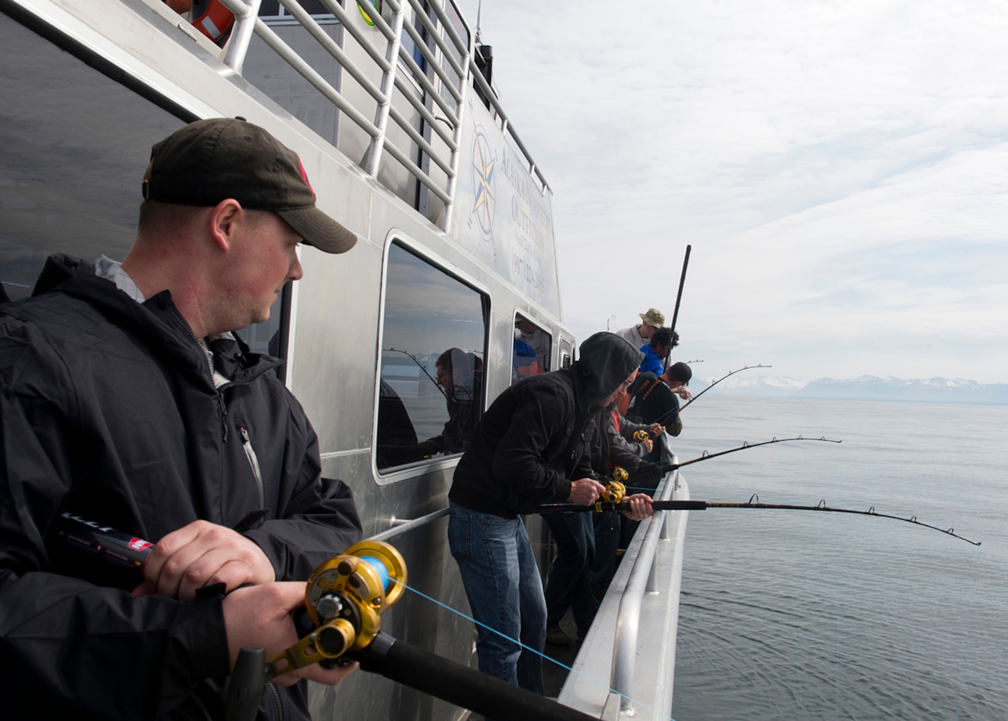 Service members from Joint Base Elmendorf-Richardson fish aboard Sea Quest during the Annual Armed Services Combat Fishing Tournament in Seward, Alaska, May 22, 2014. The tournament saw approximately 200 active-duty military members participate and the fish caught ranged from halibut to rockfish. (U.S. Air Force photo/Staff Sgt. Zachary Wolf)