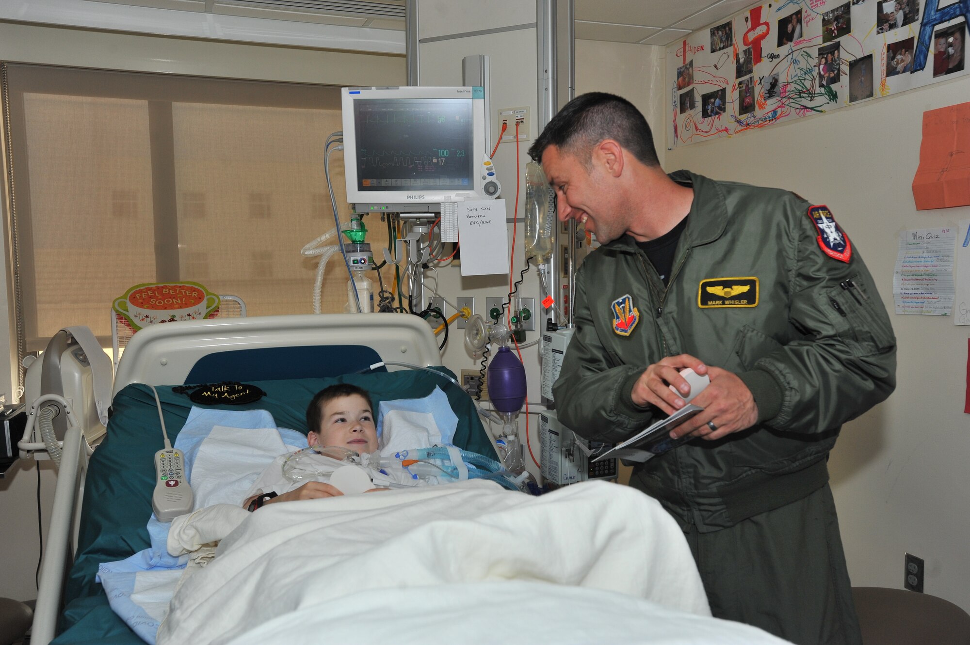 Maj. Mark Whisler, U.S. Air Force Viper West Heritage Flight team F-16 Fighting Falcon pilot, visits with Aiden Kemp at the Intensive Care Unit in the Sacred Heart Medical Hospital in Spokane, Wash., May 29, 2014.  The team visited the children to bring wishes and SkyFest memorabilia to those who couldn’t attend the event.  (U.S. Air Force photo by Staff Sgt. Veronica Montes/Released)