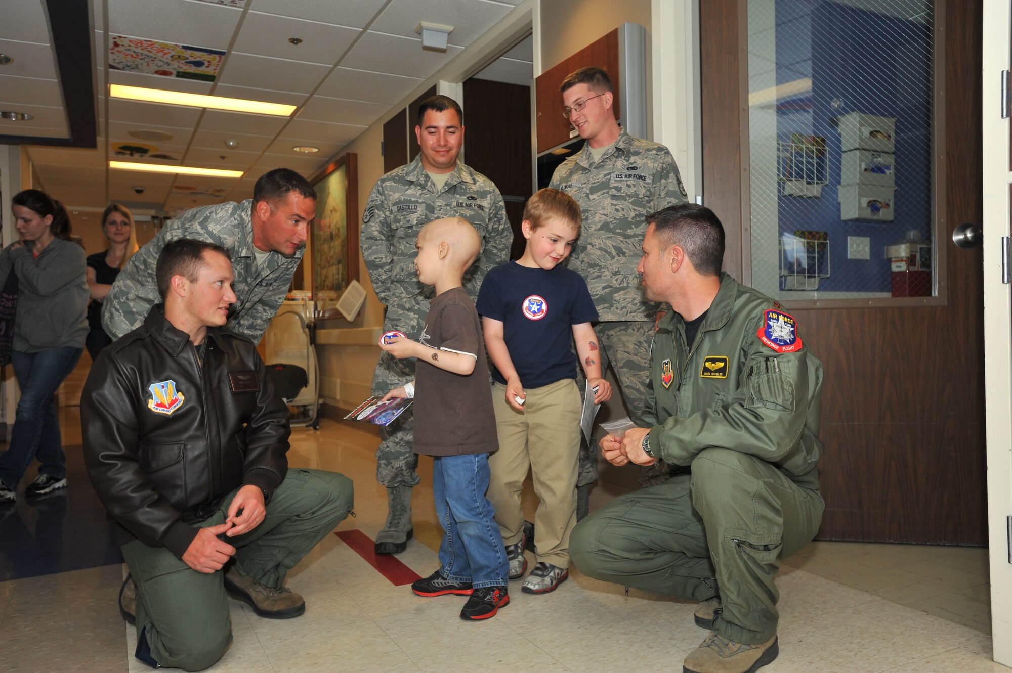 Members from the U.S. Air Force Viper West Heritage Flight team visit with children at the Sacred Heart Medical Hospital in Spokane, Wash., May 29, 2014.  The team visited the children to bring wishes and SkyFest memorabilia to those who couldn’t attend the event.  (U.S. Air Force photo by Staff Sgt. Veronica Montes/Released)