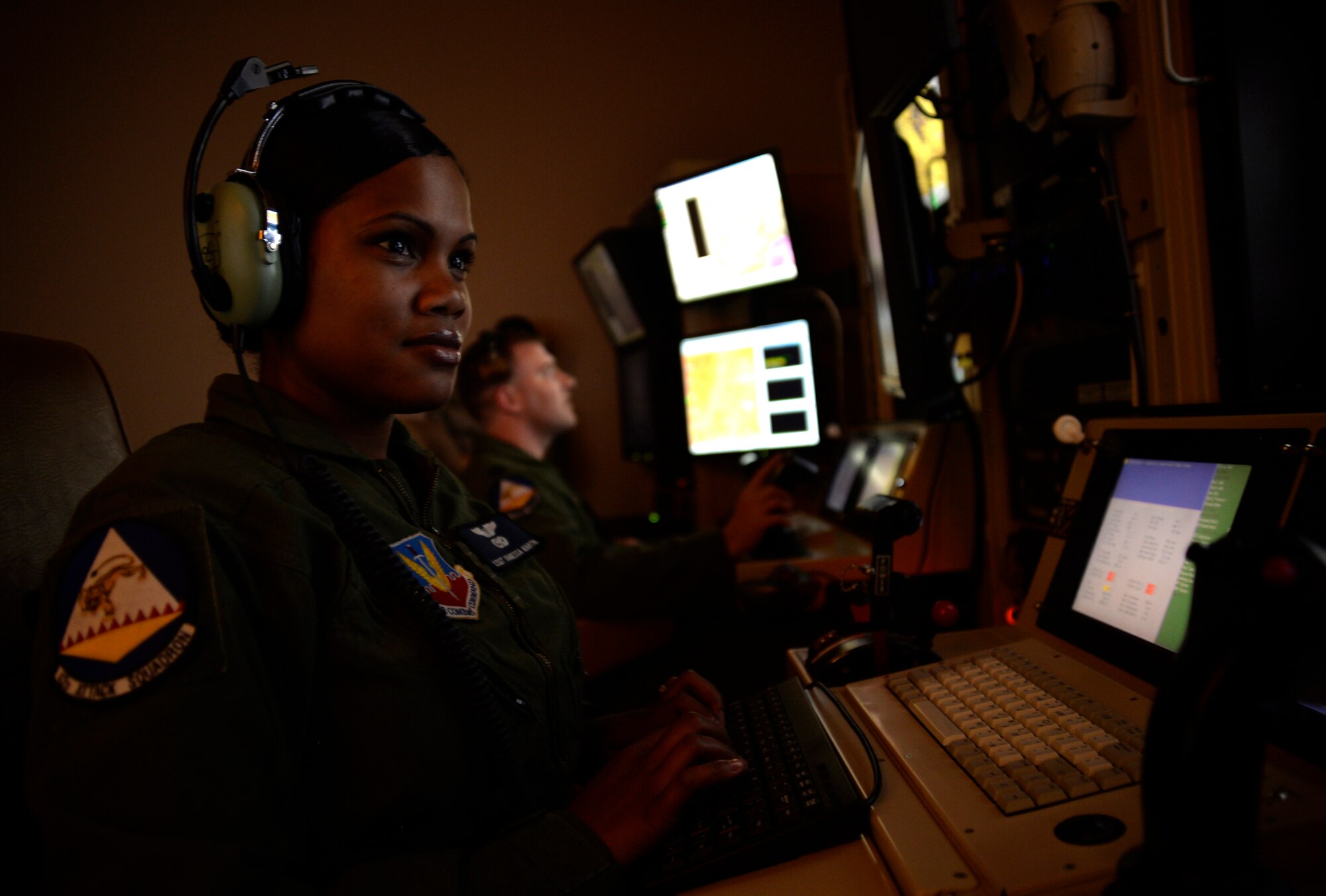 Staff Sgt. Vanessa, 42nd Attack Squadron sensor operator, front, and Capt. Andrew, 18th Reconnaissance Squadron pilot, follow a vehicle with a remotely piloted aircraft in a flight training simulator May 28, 2014. The two person crew was selected to fly the 65th air combat patrol, an initiative set by then Secretary of Defense Robert Gates Dec. 23, 2009 (Last names have been withheld for security purposes). (U.S. Air Force photo by Staff Sgt. Adawn Kelsey/Released)