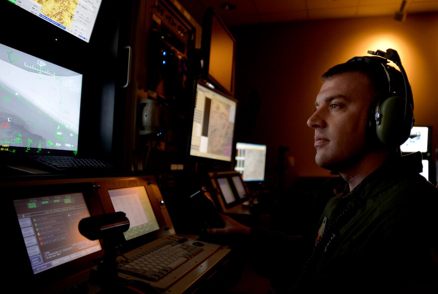 Capt. Andrew, 18th Reconnaissance Squadron pilot, flies a remotely piloted aircraft using a flight training simulator May 28, 2014, after flying the 65th combat air patrol, which launched earlier that morning. Andrew was selected to fly the 65th CAP, an initiative set by then Secretary of Defense Robert Gates Dec. 23, 2009 (Last names have been withheld for security purposes). (U.S. Air Force photo by Staff Sgt. Adawn Kelsey/Released)