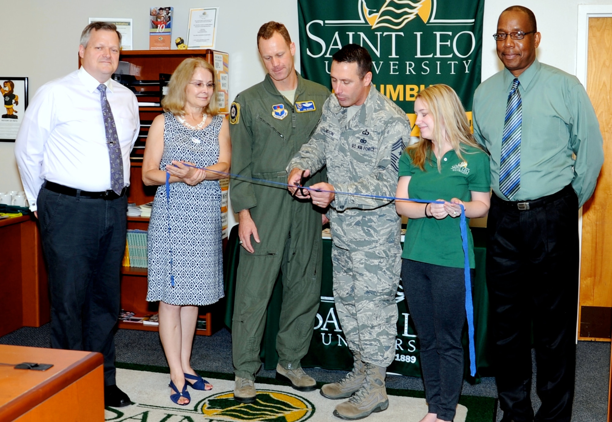 Chief Master Sgt. Vance Kondon, 14th Flying Training Wing Command Chief, cuts a ribbon in recognition of the National Test Center opening at Columbus Air Force Base, Miss, June 3. Education Service staff and Saint Leo University staff members held the event, as well as an open house, to celebrate the new opportunity to administer computer based testing for College-Level Examination Program® and more without having to travel to Mississippi State University or Meridian, Miss. (U.S. Air Force photo/ Elizabeth Owens)