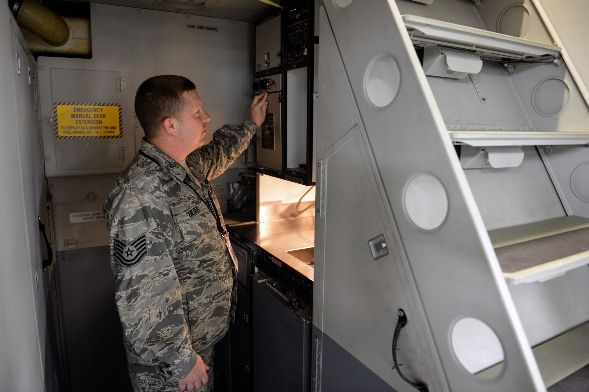 Tech. Sgt. Joseph Bilger, 62nd Maintenance Squadron product improvement manager, highlights some of the features of the buffet and galley subsystem inside a C-17 Globemaster III June 4, 2014, at Joint Base Lewis-McChord, Wash. The small galley consists of a refrigerator, freezer, coffee maker, sink, waste container and an oven, making it essential for the comfort of aircrews and passengers on board. (U.S. Air Force photo/Staff Sgt. Russ Jackson)