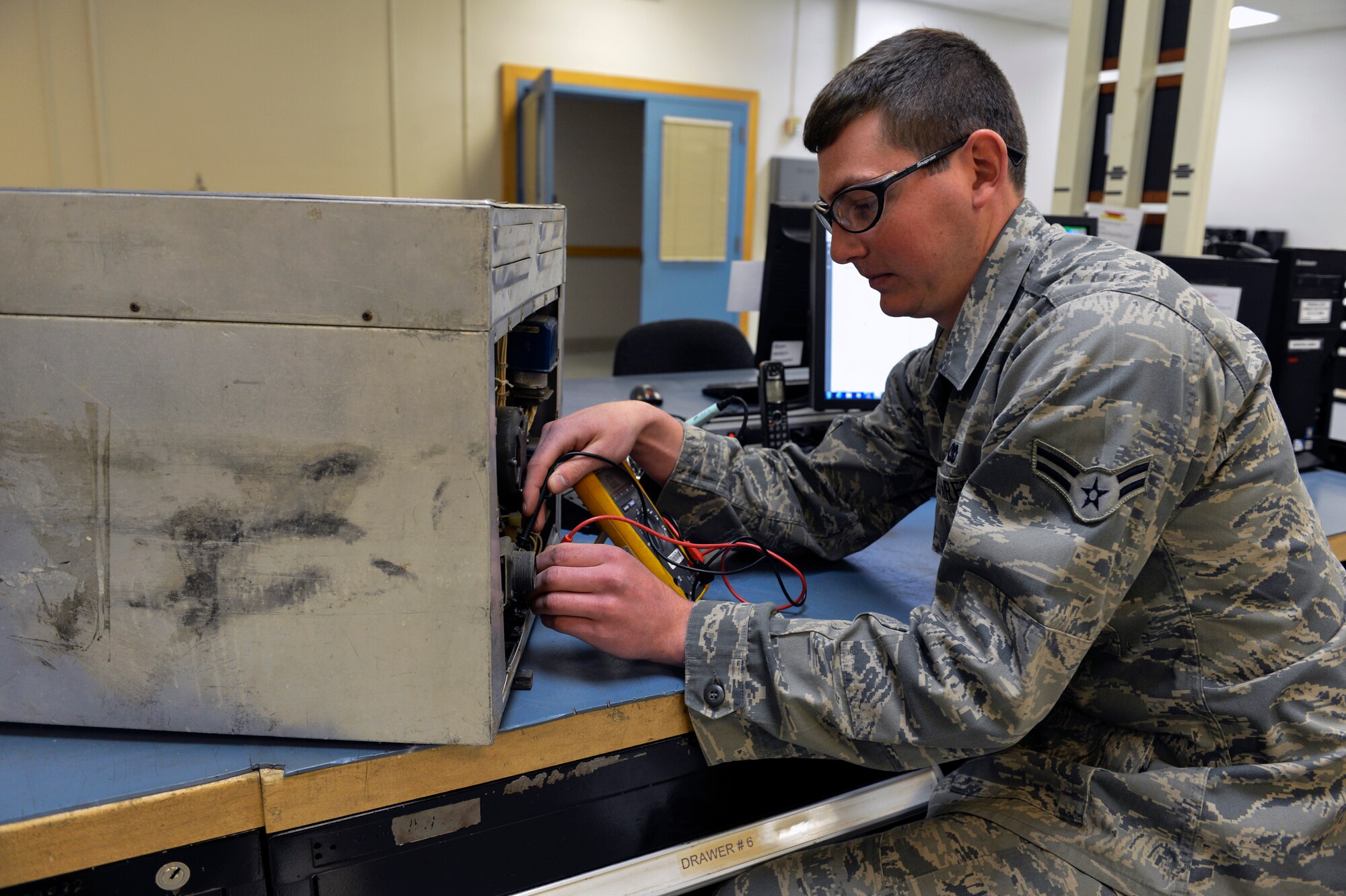 Airman 1st Class Jake Bucklaw, 62nd Maintenance Squadron aircraft electrical and environmental systems apprentice, checks the continuity of the wiring for an oven belonging to a C-17 Globemaster III buffet and galley subsystem June 4, 2014, at Joint Base Lewis-McChord, Wash. Maintainers discovered an unserviceable galley had been erroneously turned in to the Defense Reutilization and Marketing Office, and repaired it with nothing more than a $2 light bulb. (U.S. Air Force photo/Staff Sgt. Russ Jackson)