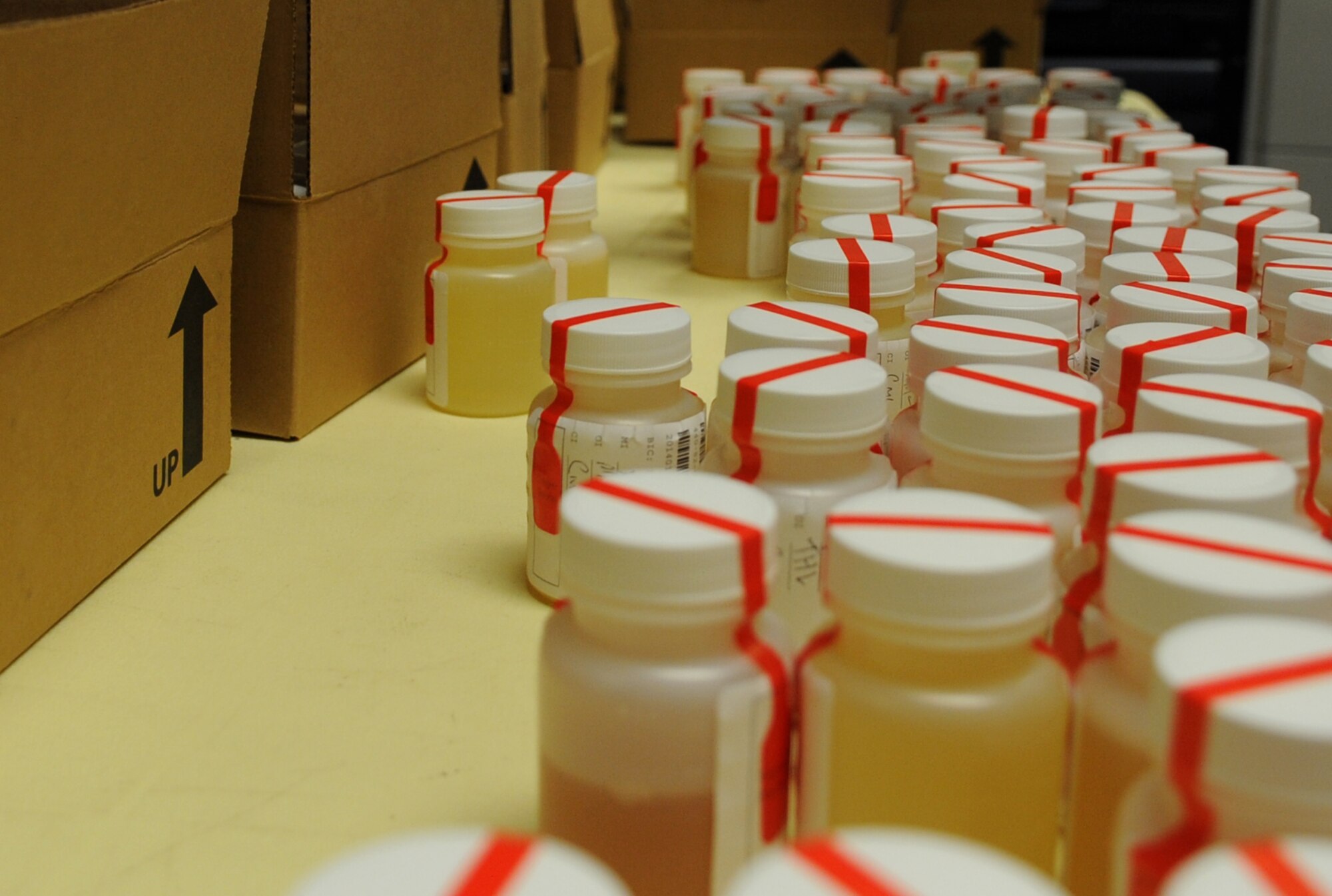 Specimen bottles are collected for packaging for drug testing Jan. 7, 2014, at Little Rock Air Force Base, Ark. The 19th Medical Group Drug Demand Reduction office collects and tests service members and civilians for substance abuse. (U.S. Air Force photo by Staff Sgt. Caleb Pierce) 