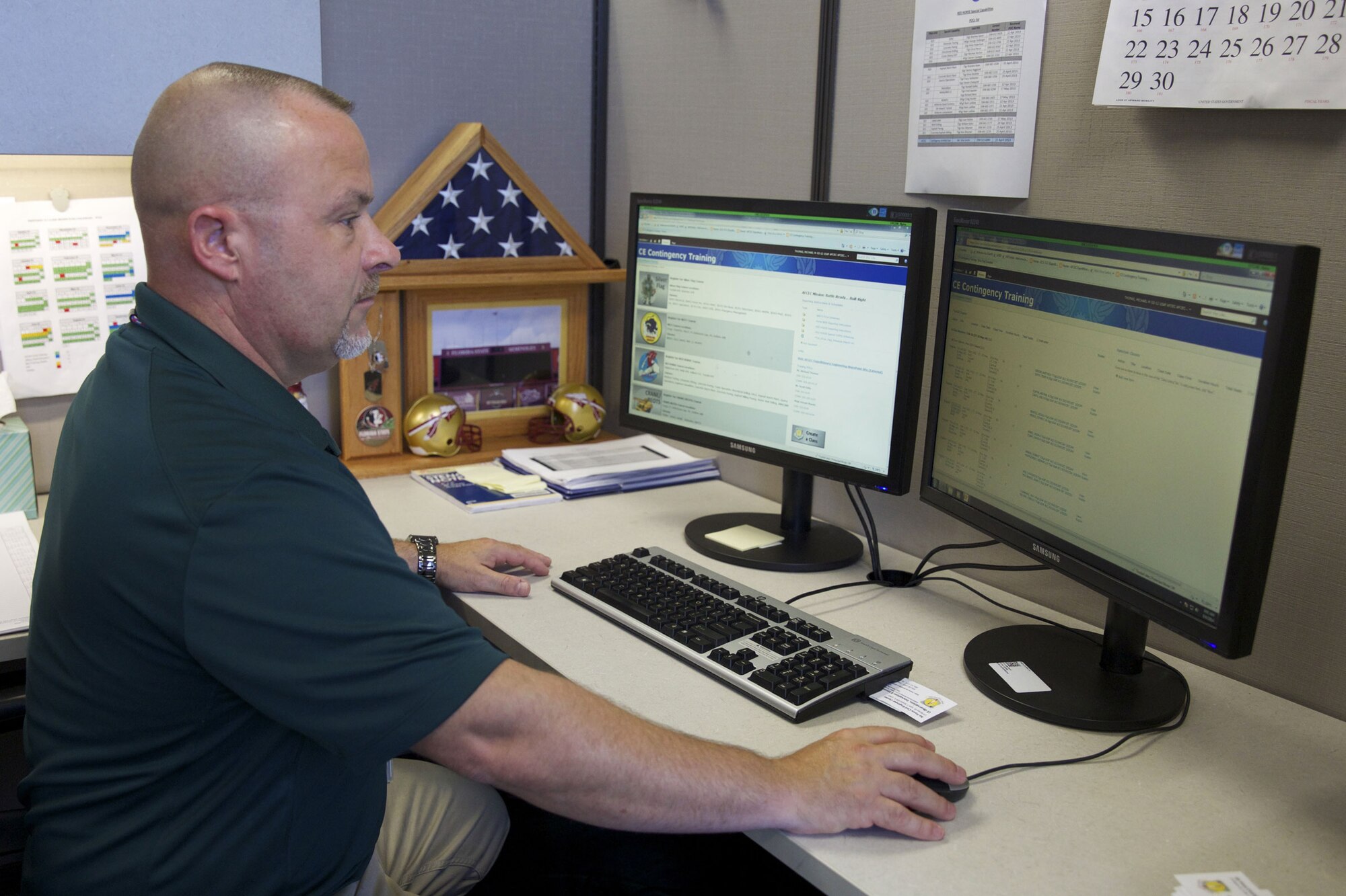Michael Thomas, contingency training scheduler in AFCEC’s Readiness Directorate Expeditionary Engineering Division, looks over a schedule for an upcoming Silver Flag class on the new SharePoint-based CE contingency training site. The division reached out to AFCEC’s information technology team for help developing a solution to manage Air Force civil engineer contingency training for more than 32,000 active-duty, Guard and Reserve CEs. (U.S. Air Force photo/Eddie Green/Released)