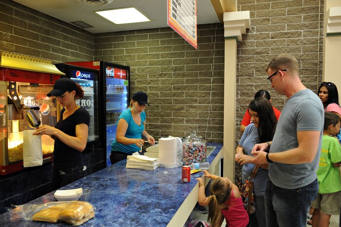 Beale's theater staff serves Team Beale popcorn and refreshments before a movie June 4, 2014, at Beale Air Force Base, Calif. The renovated theater is now offering free admission. (U.S. Air Force photo by Airman 1st Class Ramon A. Adelan/ released)