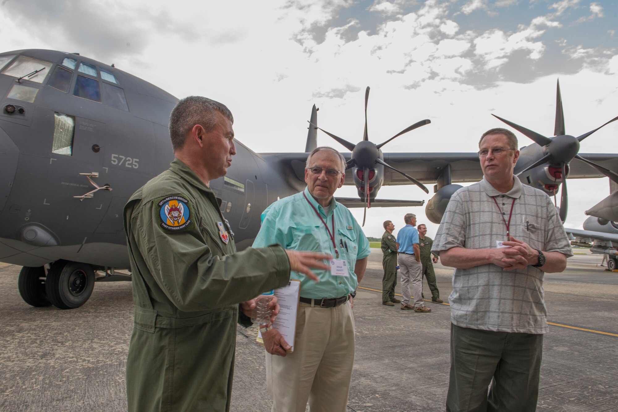 U.S Air Force Chief Master Sgt. Maxie Gainey, 347th Rescue Group chief enlisted officer, talks to Douglas Leavitt and Steve Harris, Combat Search and Rescue (CSAR) Society members, about the HC-130J Combat King II at Moody Air Force Base, Ga., May 28, 2014. The last time the CSAR Society visited Moody was in May 2008. (U.S. Air Force photo by Airman Dillian Bamman/Released)