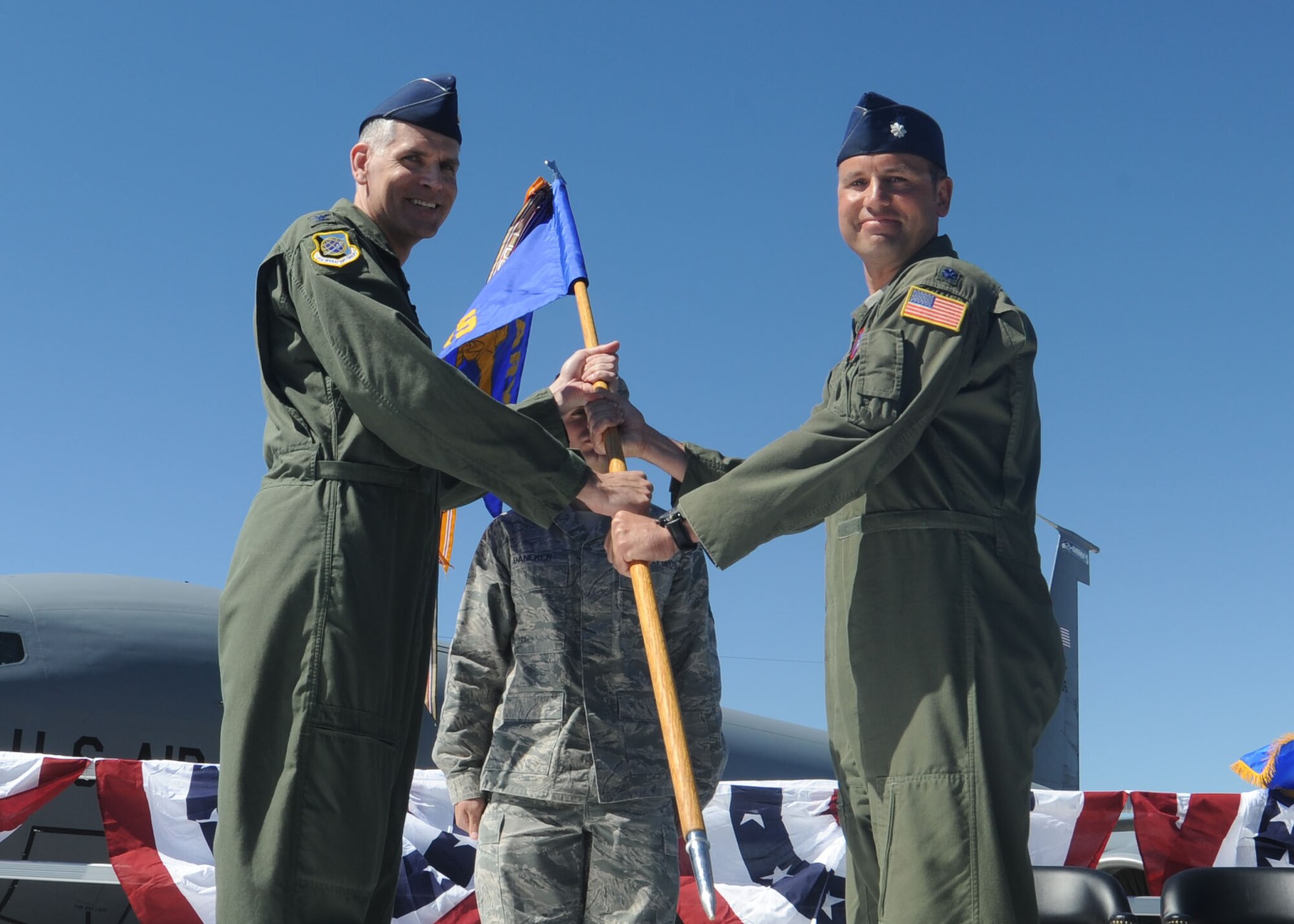 Col. Shawn Teagan passes the 93rd Air Refueling Squadron guidon to Lt. Col. Nate Vogel during a change of command ceremony at Fairchild Air Force Base, Wash., June 5, 2014. Teagan is the 92nd Operations Group commander and Vogel is the new 93rd ARS commander. (U.S. Air Force photo by Airman 1st Class Sam Fogleman/Released)