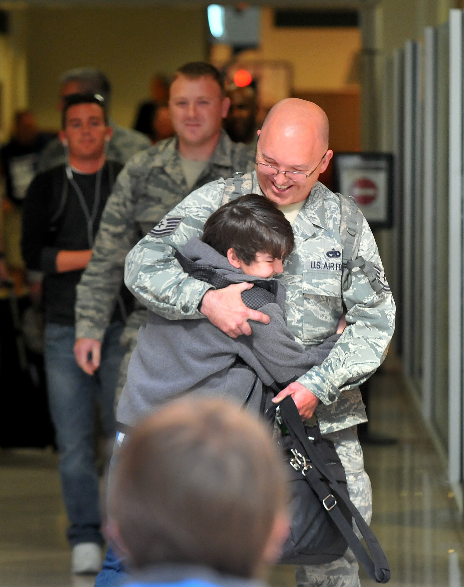 WRIGHT-PATTERSON AIR FORCE BASE, Oho – Tech. Sgt. David Kalb, 87th Aerial Port Squadron, is greeted by his son, Lucas, at the Dayton International Airport May 3 upon his return home from his deployment. Kalb and three 87 APS Airmen were returning home from their eight-month deployment to the Transit Center, Manas, Kyrgyzstan.  (U.S. Air Force photo/Tech. Sgt. Frank Oliver)