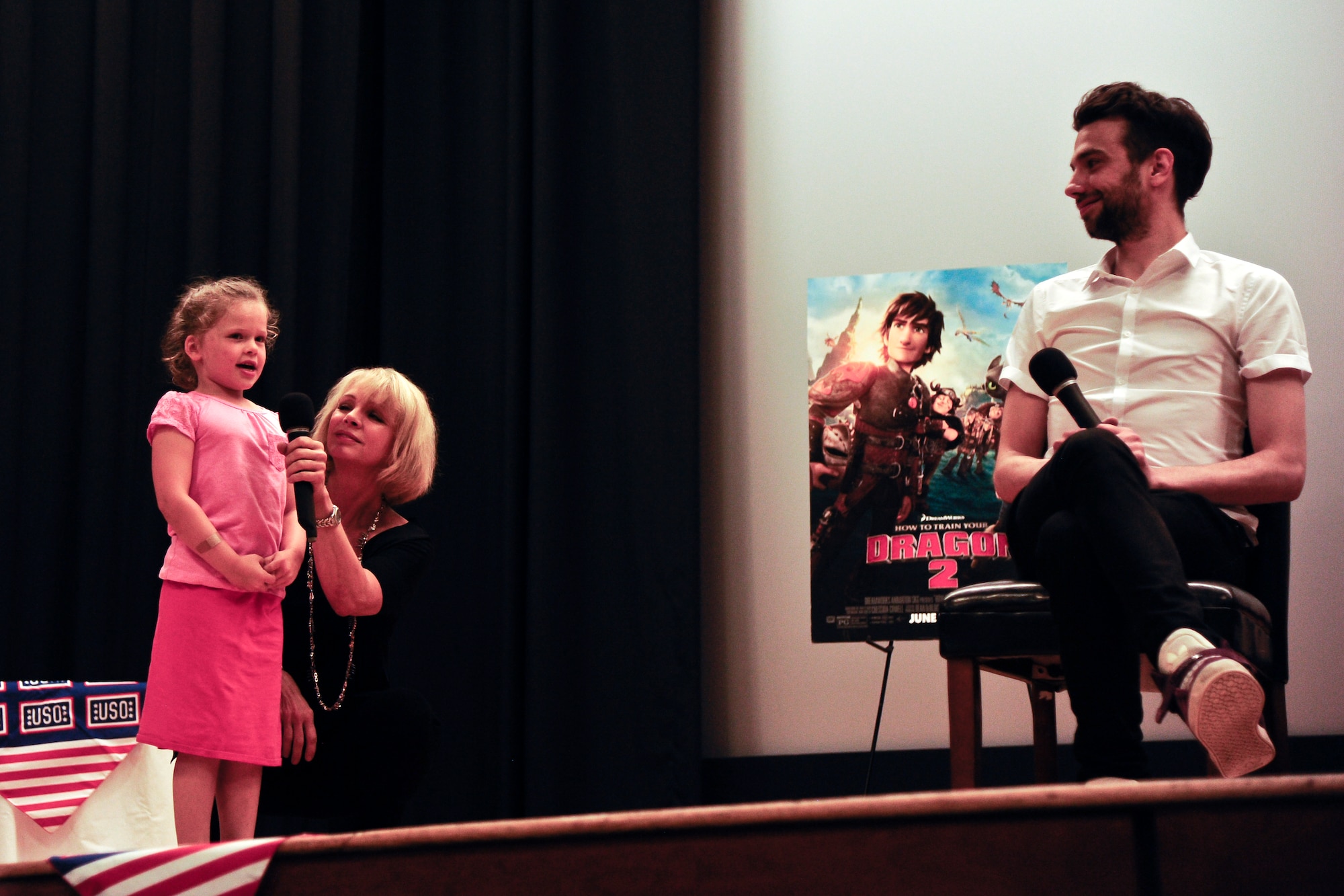 An audience member attending an advanced screening of “How to Train Your Dragon 2” asks a question to Jay Baruchel, voice of Hiccup, June 4, 2014, at Joint Base McGuire-Dix-Lakehurst, N.J. The visit to JB MDL was part of a USO tour allowing military families the ability to view the movie a week early, ask cast members questions and get autographs. (U.S. Air Force photo by Staff Sgt. Scott Saldukas/ Released)