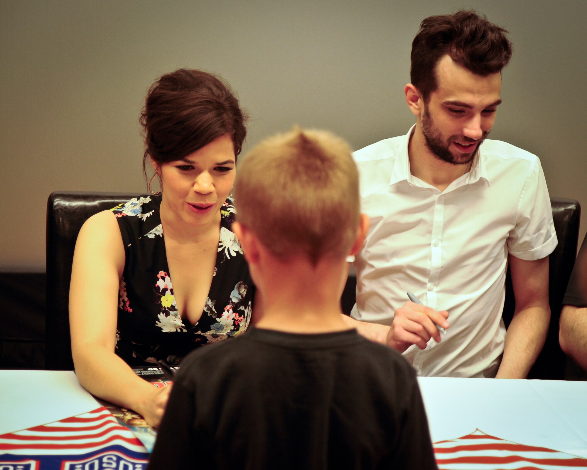 America Ferrara and Jay Baruchel, voices of characters in the new movie “How to Train Your Dragon 2”, sign autographs during a USO tour June 4, 2014, at Joint Base McGuire-Dix-Lakehurst. The tour allowed military families the ability to view the new movie a week early, ask cast members questions and get autographs. (U.S. Air Force photo by Staff Sgt. Scott Saldukas/ Released)  