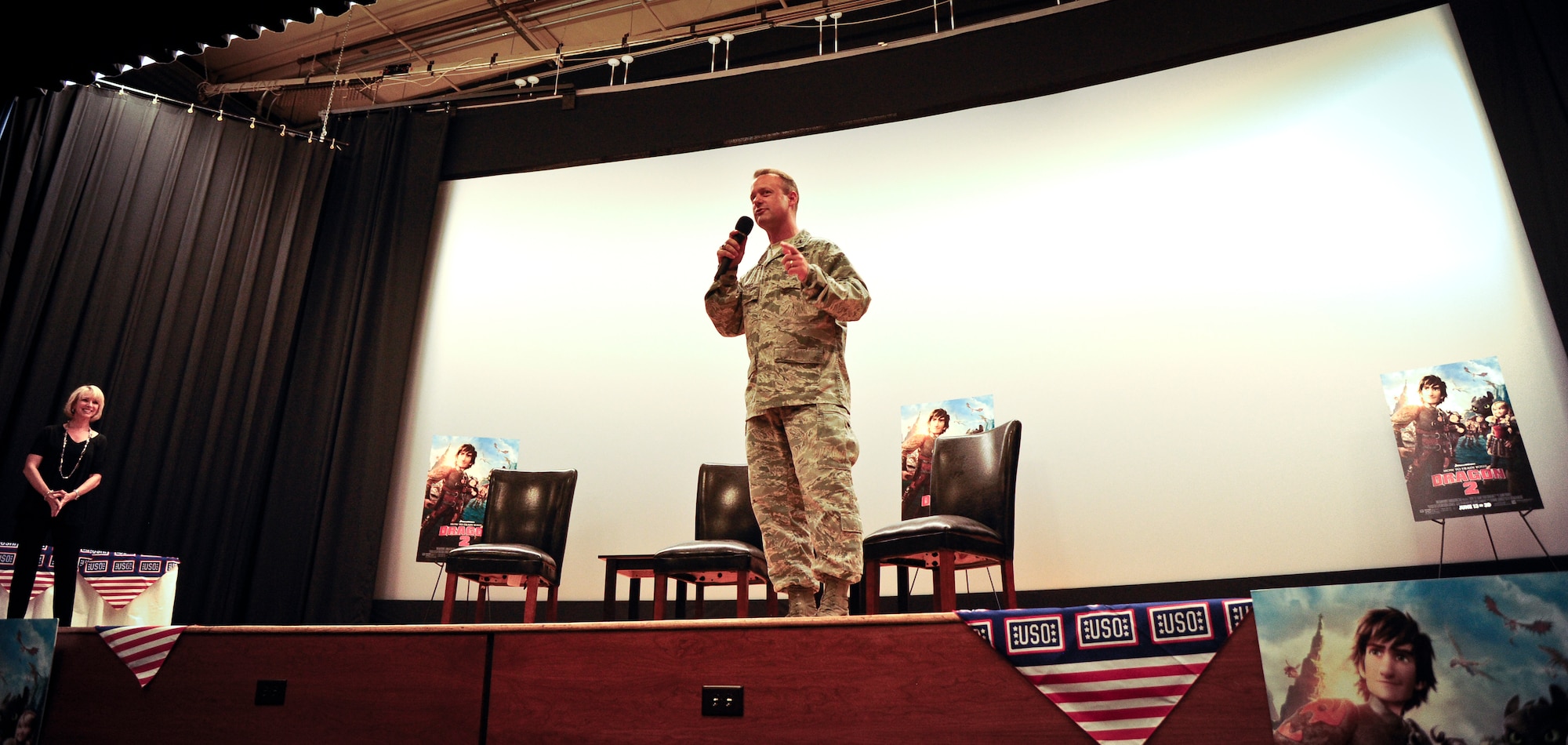 Air Force Col. James Hodges, Joint Base McGuire-Dix-Lakehurst, N.J., commander, addresses the attendees of the “How to Train Your Dragon 2” advanced screening June 4, 2014, here. Following the movie, cast members Dean DeBlois, writer and director, Jay Baruchel, voice of Hiccup, and America Ferrara, voice of Astrid, answered audience questions and signed autographs for military members and their families. (U.S. Air Force photo by Staff Sgt. Scott Saldukas/ Released) 