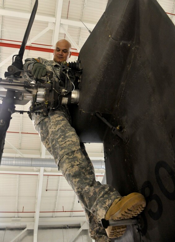 U.S. Army Chief Warrant Officer 2 Josh Brewer, 1-135th Attack Reconnaissance Battalion alpha company maintenance test pilot, pre-flights an AH-64 Apache at Whiteman Air Force Base, Mo., May 14, 2014. This is done in preparation to ensure air worthiness of the aircraft after maintenance operations. (U.S. Air Force photo by Airman 1st Class Keenan Berry/Released)  