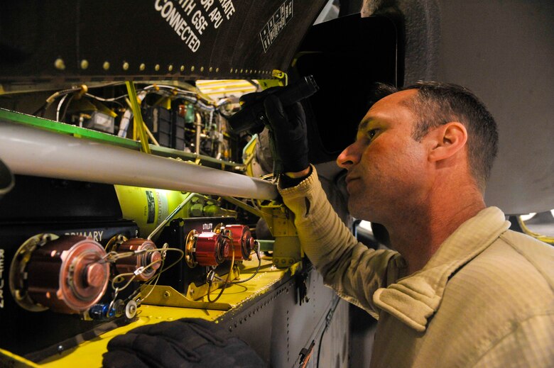 U.S. Army Chief Warrant Officer 3 Phillip Little, 1-135th Attack Reconnaissance Battalion bravo company maintenance test pilot, pre-flights an AH-64 Apache at Whiteman Air Force Base, Mo., May 14, 2014. This is done in preparation to ensure air worthiness of the aircraft after maintenance operations. (U.S. Air Force photo by Airman 1st Class Keenan Berry/Released)